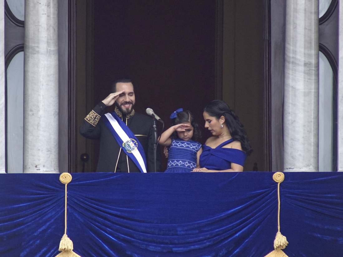 El Salvador's President Nayib Bukele and his daughter Layla salute while standing on a balcony with first lady Gabriela Roberta Rodríguez, after he was sworn in for a second term, in San Salvador, El Salvador, Saturday, June 1, 2024.