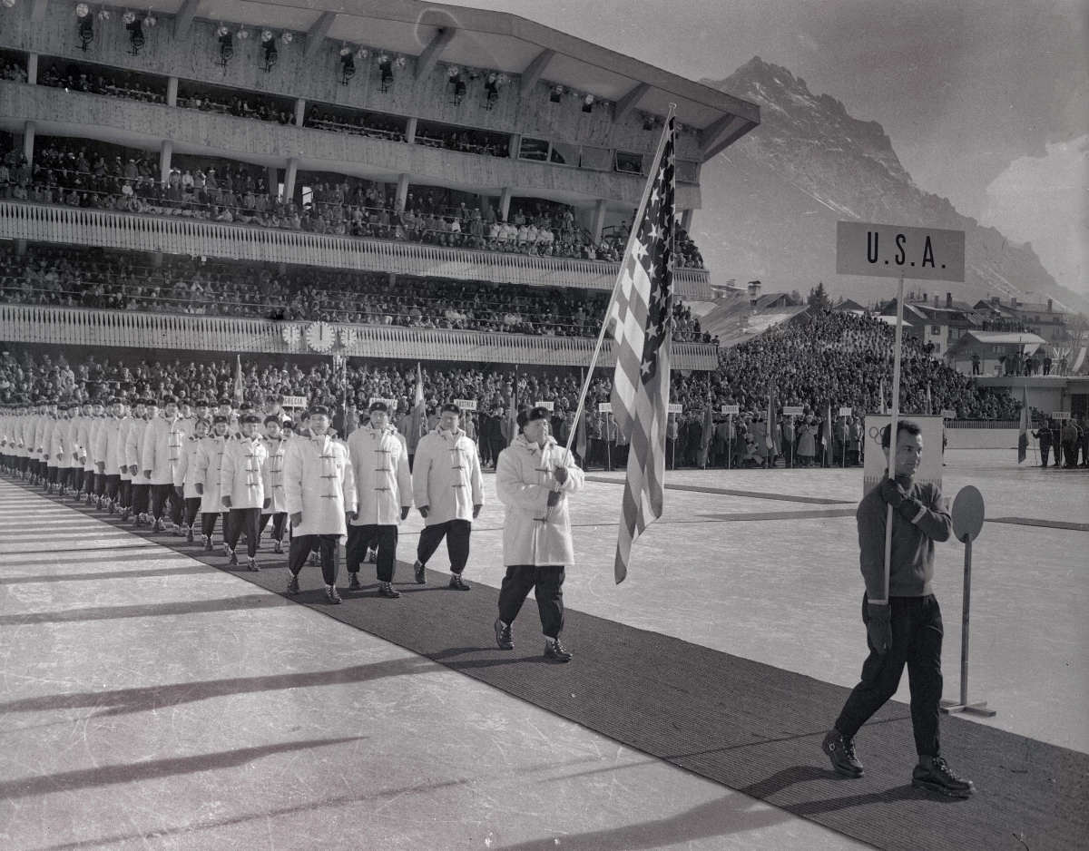 Members of the U.S. Olympic teams walk during the procession into Cortina's huge ice stadium for opening ceremonies launching 11 days of competition in the 1956 Winter Olympics.