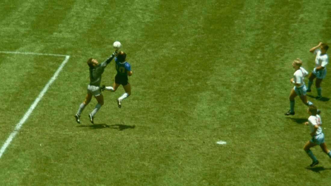 Argentina's Diego Maradona scores his infamous "Hand of God" goal over England goalkeeper Peter Shilton during the 1986 FIFA World Cup quarter-final at Mexico City's Azteca Stadium on June 22, 1986, as England defenders Kenny Sansom (top), Gary Stevens (centre) and Terry Fenwick look on.