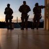 The Washington Monument is seen in the distance as members of the National Guard stand atop the steps at the Lincoln Memorial at sunrise on the National Mall in Washington, DC, on July 23, 2026.