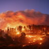 Seen in a long exposure photograph, the Park Fire burns along Highway 32 in the Forest Ranch community of Butte County, Calif., on Thursday.