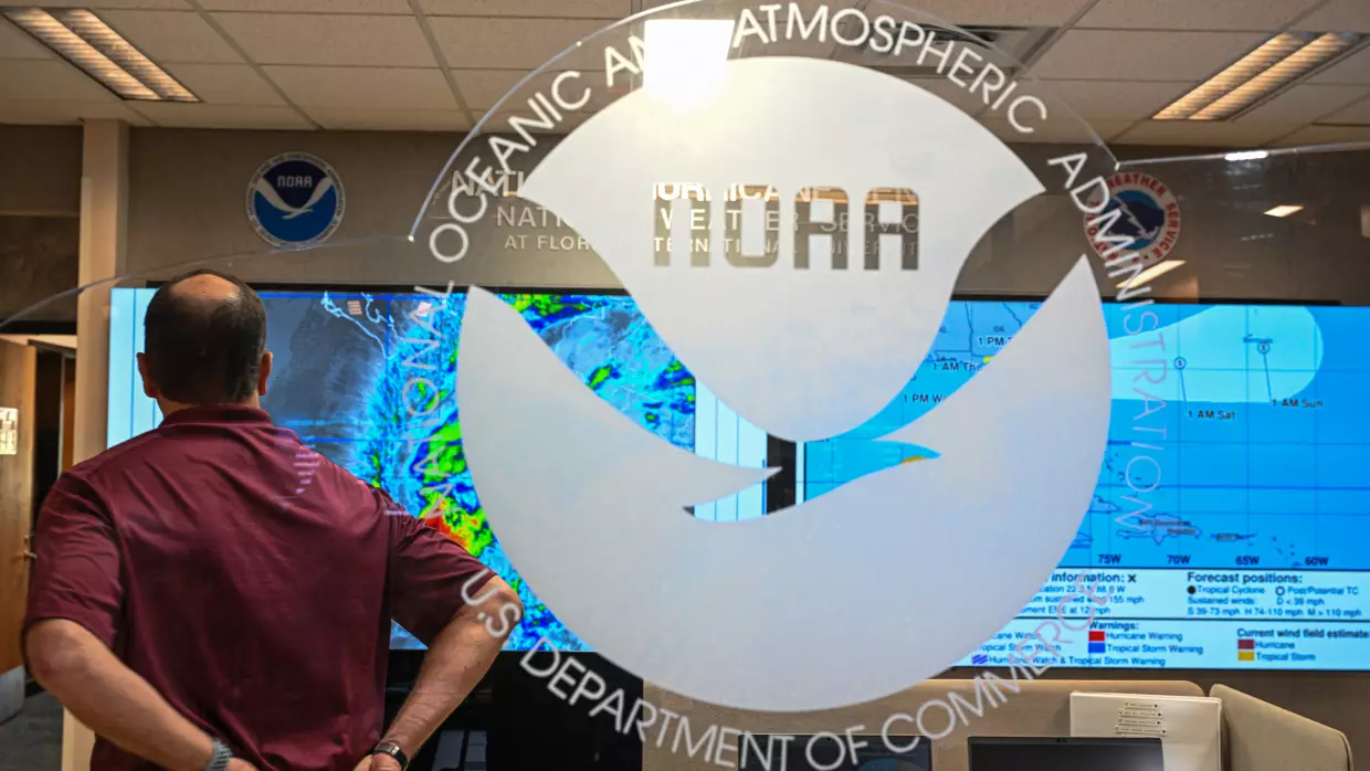 An employee looks at multiple hurricane models displayed on monitors at the National Oceanic and Atmospheric Administration's National Hurricane Center in Miami on May 30, 2025.