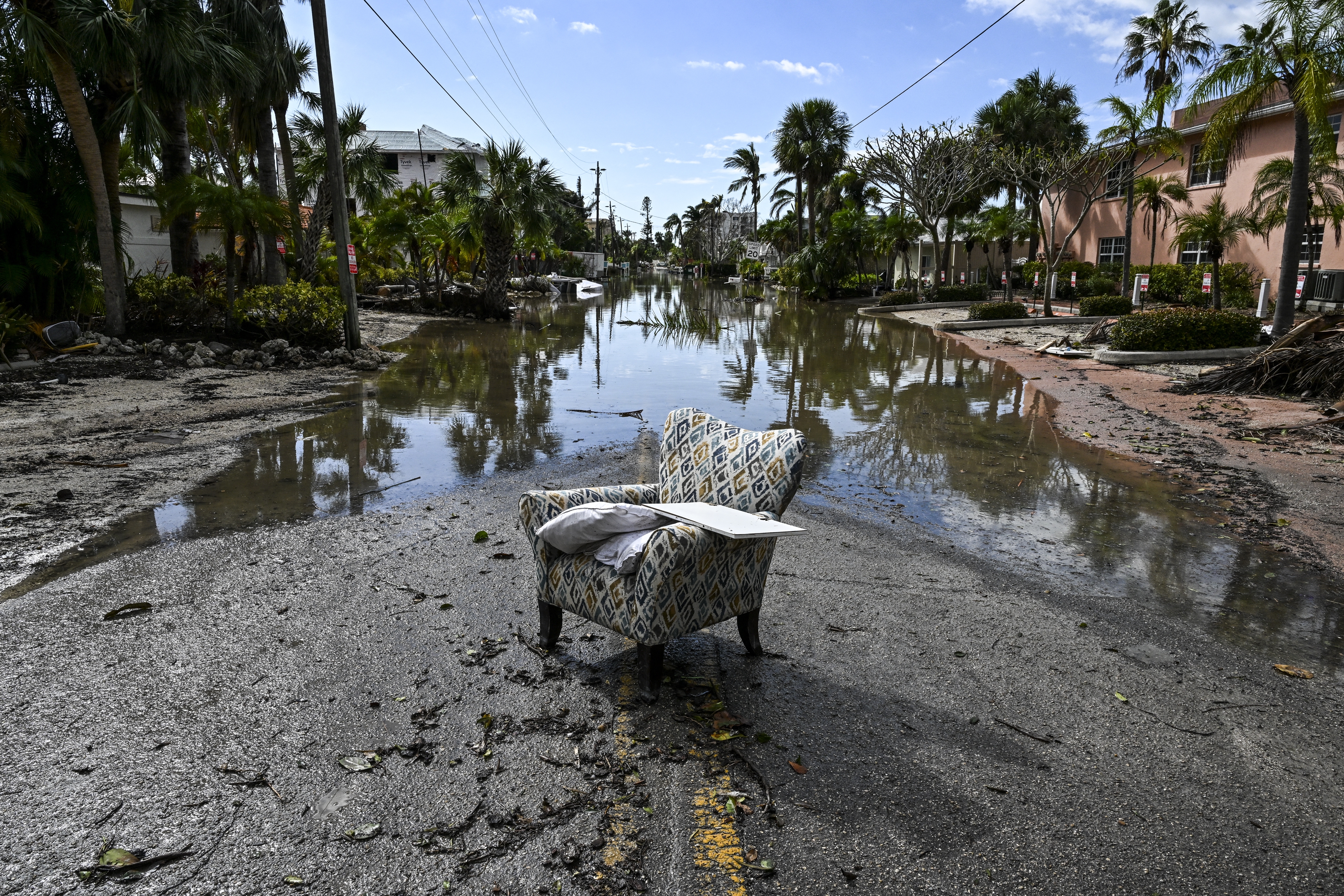 A flooded street with debris in the aftermath of Hurricane Milton, in Siesta Key, Fla., on October 10, 2024. The monster weather system sent tornadoes spinning across the state and flooded swaths of the Tampa Bay area after the storm rapidly intensified to a top-of-scale category 5 major hurricane.