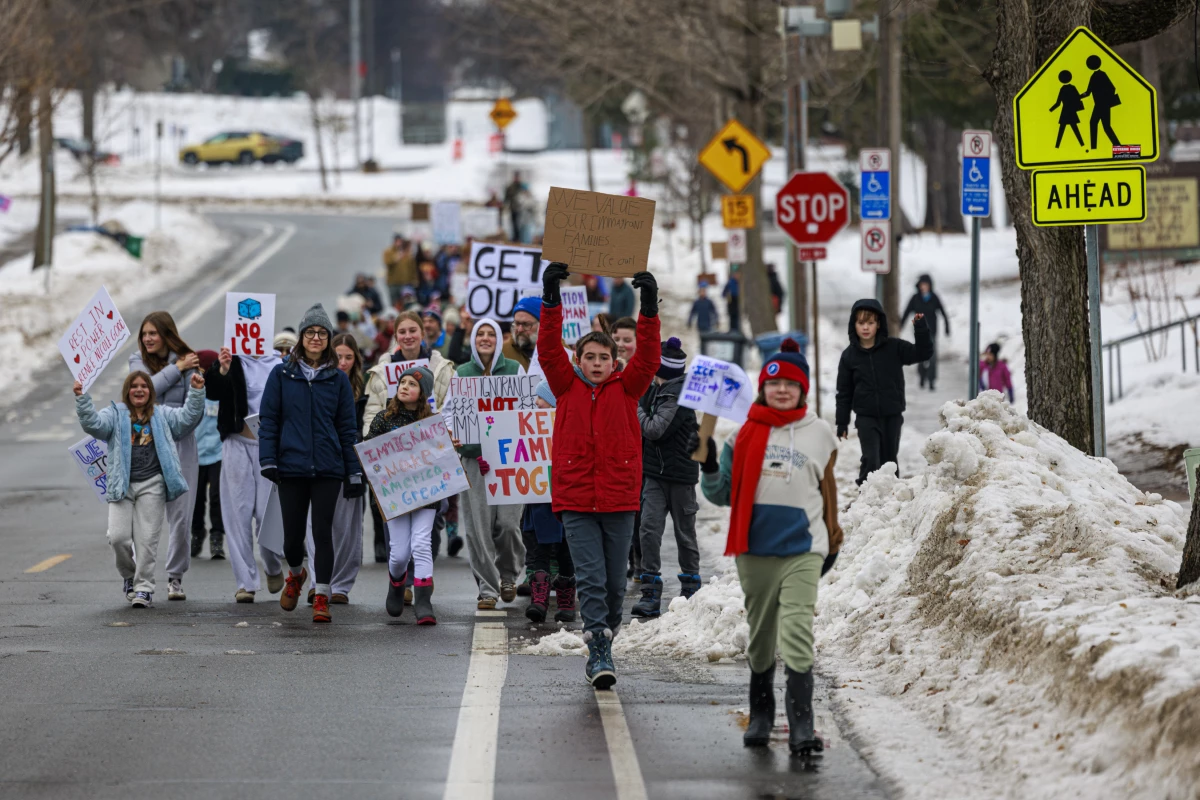 Young students march near Kenny Community School in Minneapolis, on Thursday, Jan. 8, 2026, a day after an ICE agent shot and killed a 37-year-old woman.