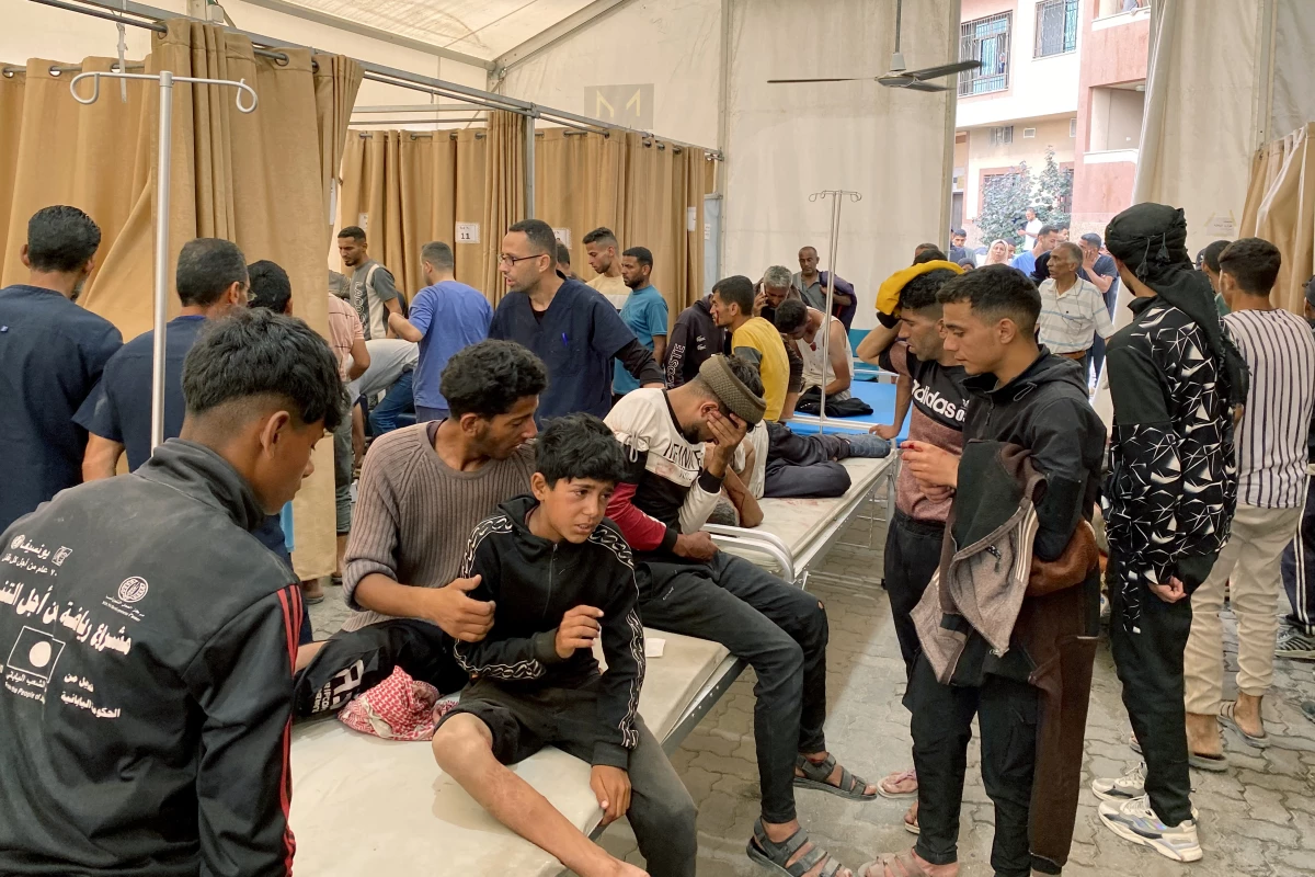 Palestinians injured in Israeli fire as they gathered near a food aid center receive care at Khan Younis' Nasser hospital in the southern Gaza Strip on Tuesday.