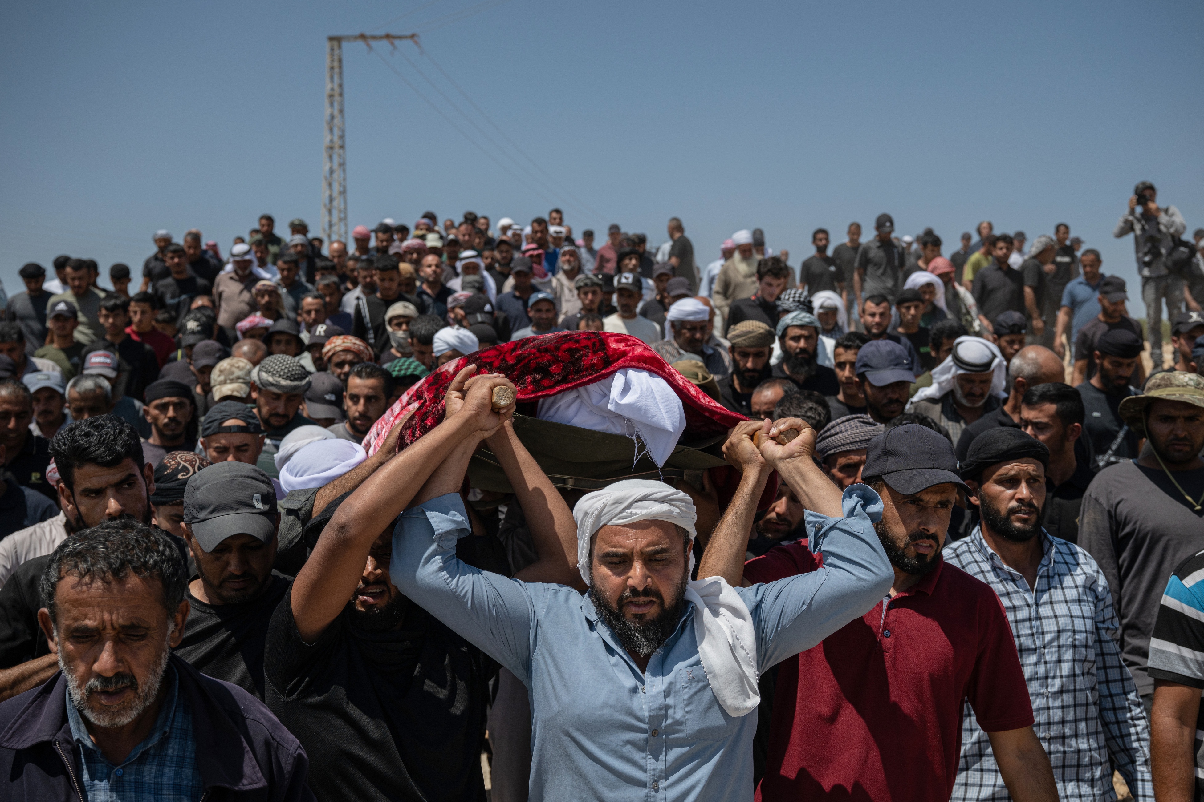 Family and friends of Awdah Al Hathaleen carry his body to the cemetery during his funeral on Aug. 7 in Umm al-Khair, West Bank.