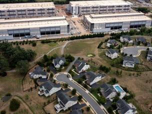 An Amazon Web Services data center is shown situated near single-family homes in Stone Ridge, Virginia.