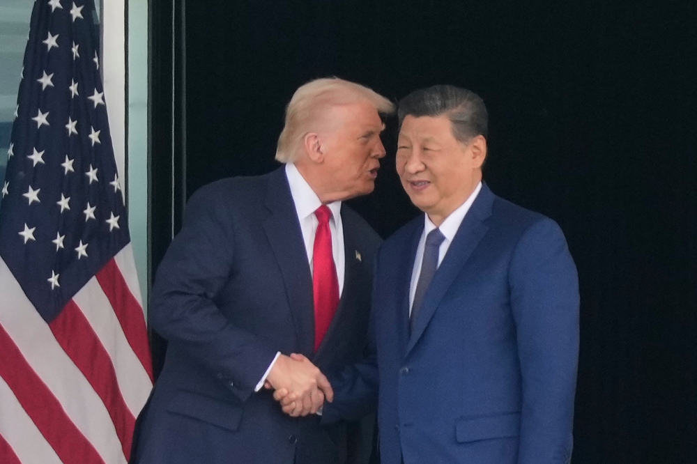 President Donald Trump, left, and Chinese President Xi Jinping, right, shake hands after their U.S.-China summit meeting at Gimhae International Airport Jinping in Busan, South Korea, Thursday, Oct. 30, 2025. (AP)