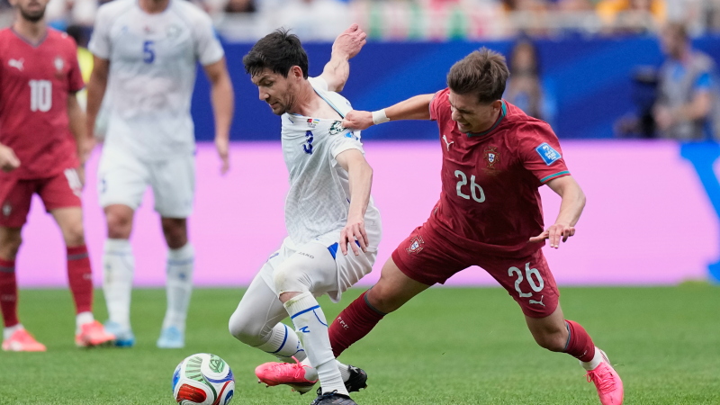 Portugal's Francisco Conceicao, right, vies for the ball with Uzbekistan's Khojiakbar Alijonov during the World Cup Group K soccer match between Portugal and Uzbekistan in Houston, Tuesday, June 23, 2026.