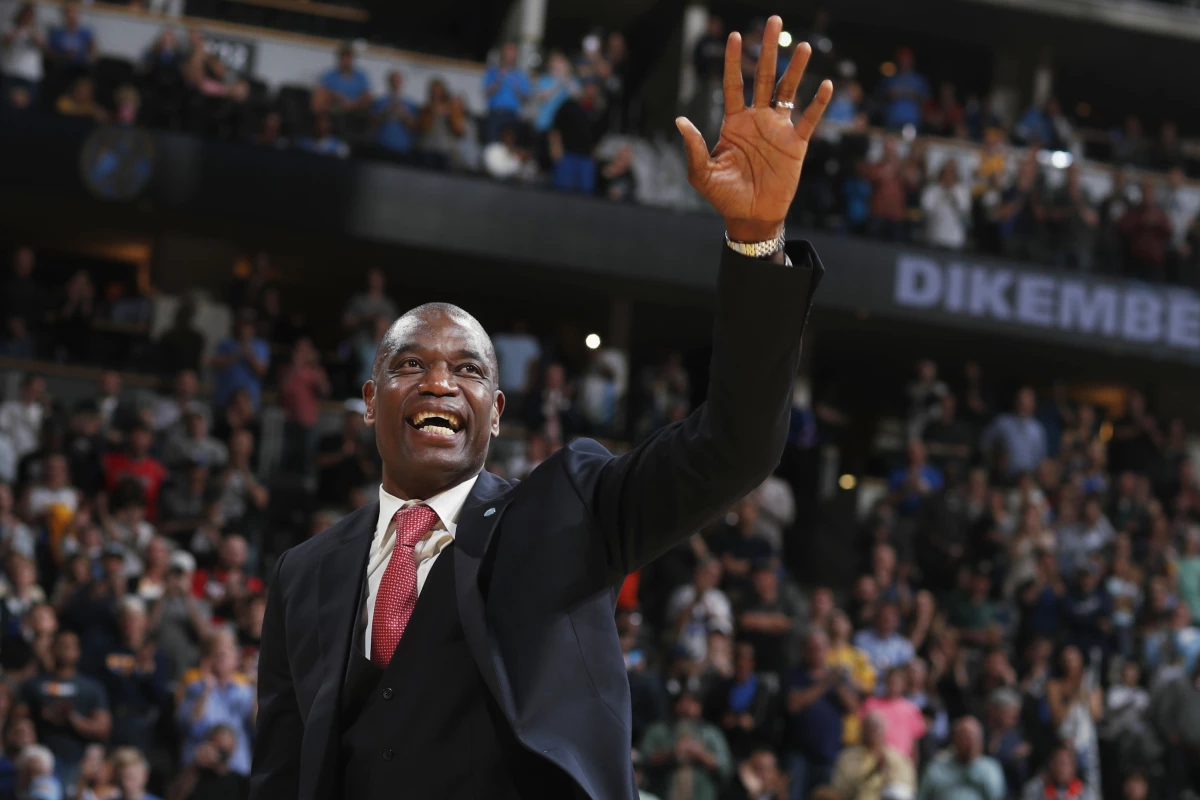 Retired Denver Nuggets center Dikembe Mutombo waves to the crowd as his jersey number was retired by the team during halftime of the Nuggets' NBA basketball game against the Portland Trail Blazers on Saturday, Oct. 29, 2016, in Denver.