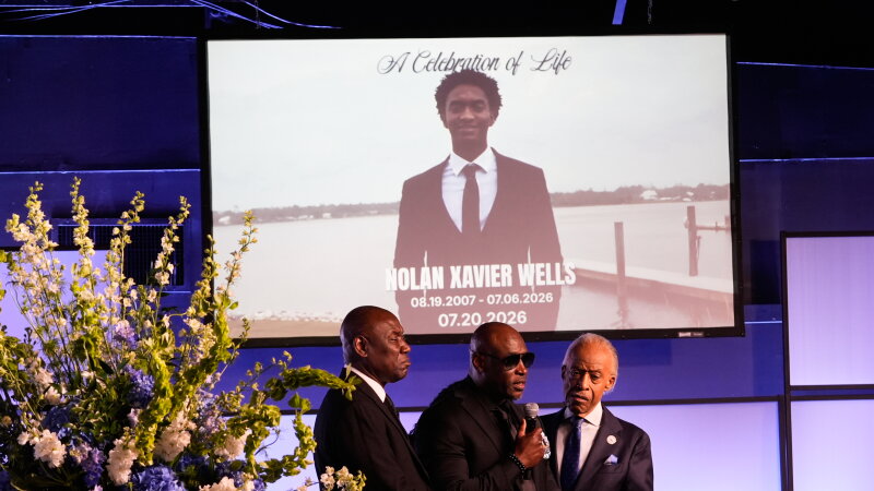 Elmore Wonsley, center, speaks next to attorney Ben Crump, left, and Rev. Al Sharpton during a memorial service for Nolan Xavier Wells on Monday.