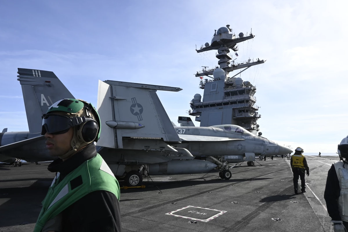 The USS Gerald R. Ford aircraft carrier has been moving toward the Middle East ahead of potential U.S. strikes on Iran. Here, an F-18E fighter jet is seen on the Ford in September in the North Sea.