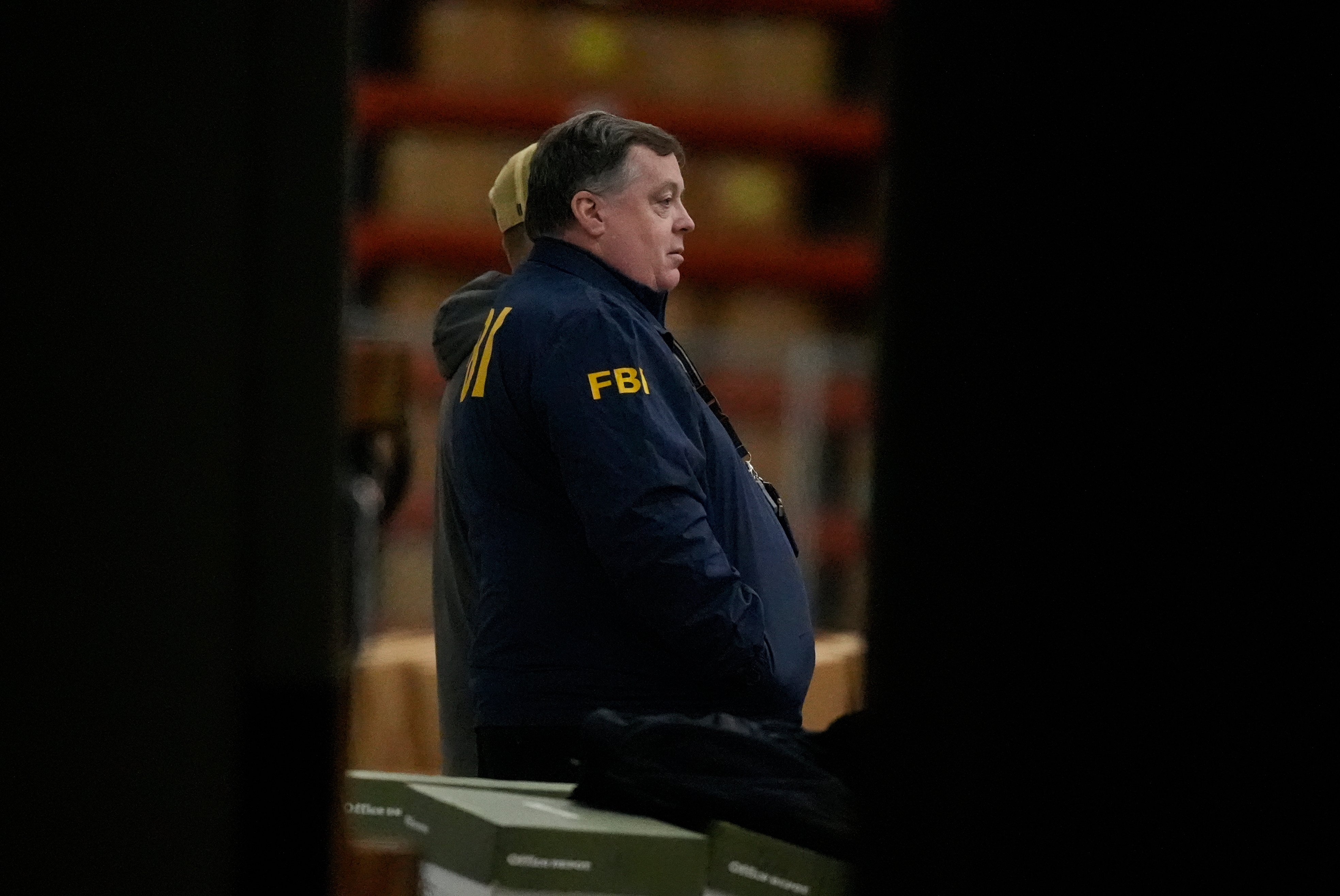 An FBI employee stands inside the Fulton County election hub, near Atlanta, as the FBI executes a search warrant for 2020 election materials, on Jan. 28. (AP)