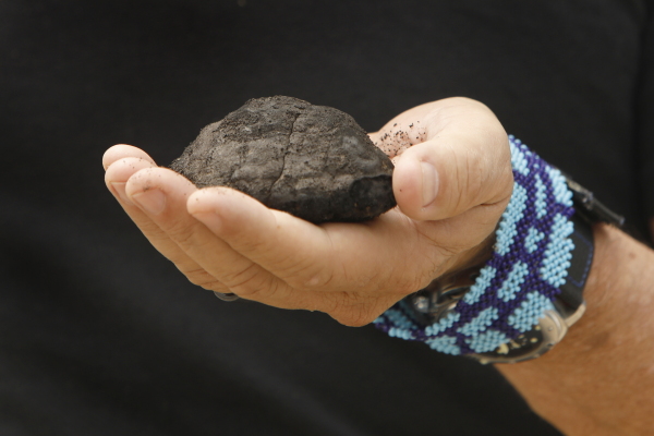 The Metals Company CEO, Gerard Barron, holds a polymetallic nodule from the sea floor. These potato-shaped deposits form over millions of years as minerals like nickel, cobalt, manganese and copper accrete around pieces of organic matter.