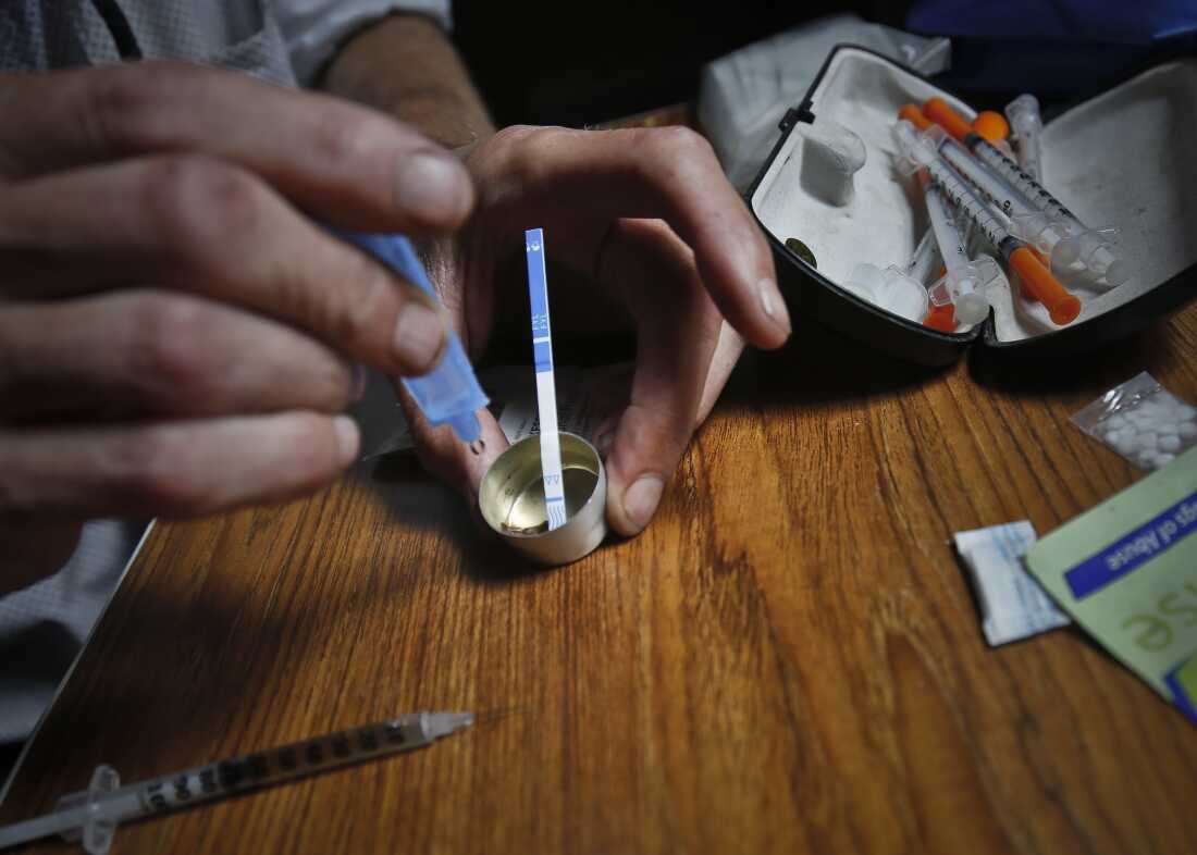 A drug user uses a test strip on Aug. 22, 2018, in New York, to see if fentanyl has been added to heroin, which could increase the risk of overdose.