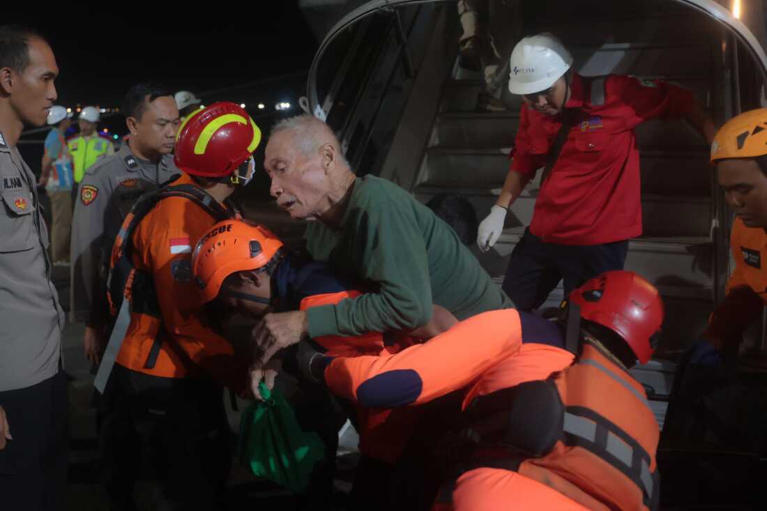 Rescuers assist a survivors of a ferry fire upon arrival at Tanjung Perak Port in Surabaya, East Java, Indonesia, Monday, Aug. 3, 2026.
