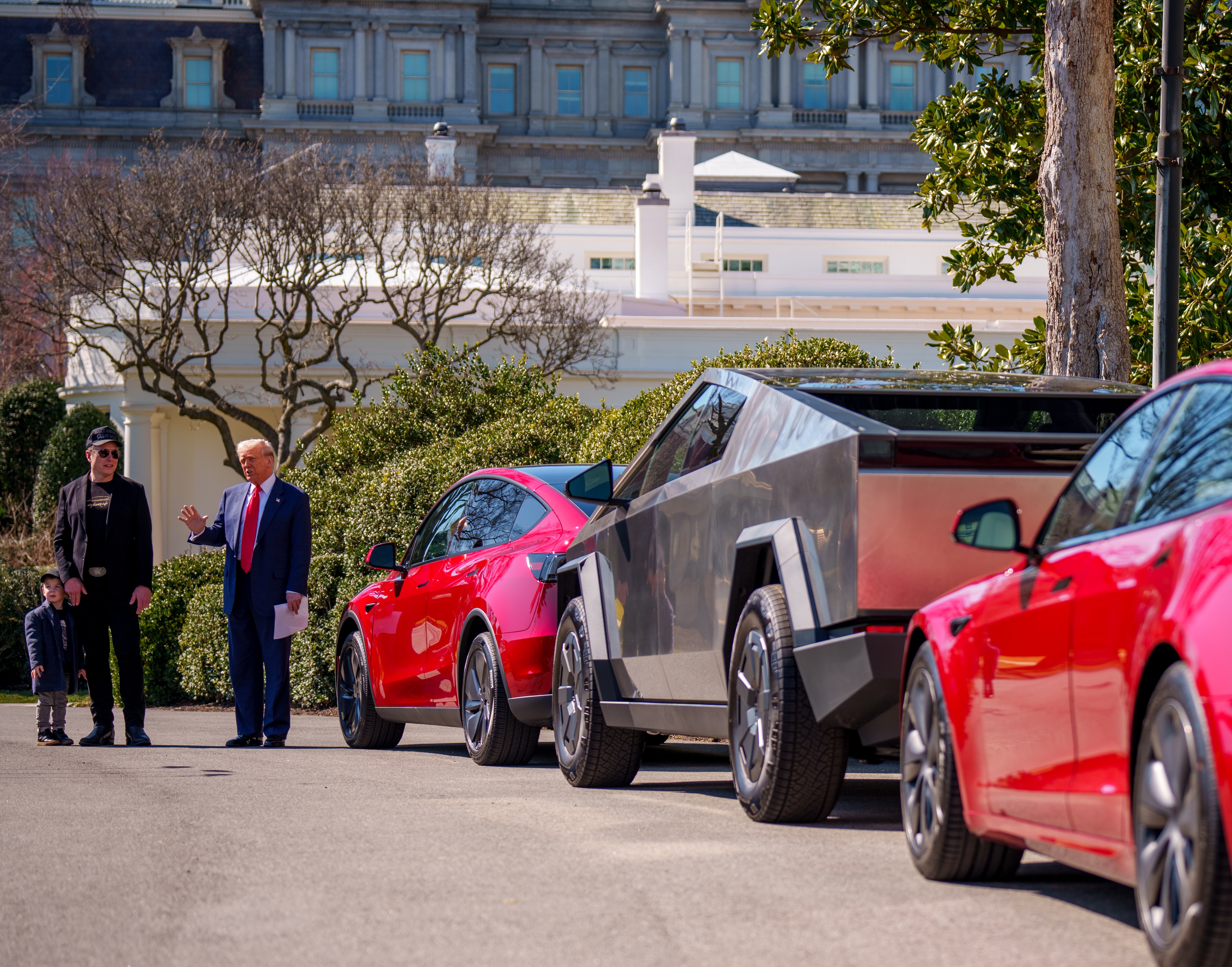 President Trump, accompanied by Tesla CEO Elon Musk and his son X Æ A-Xii, speaks next to a line of Tesla vehicles on the South Lawn of the White House on Tuesday. Trump said he would purchase a Tesla vehicle in what he calls a