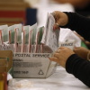 An election worker processes mail-in ballots in June in Industry, Calif.