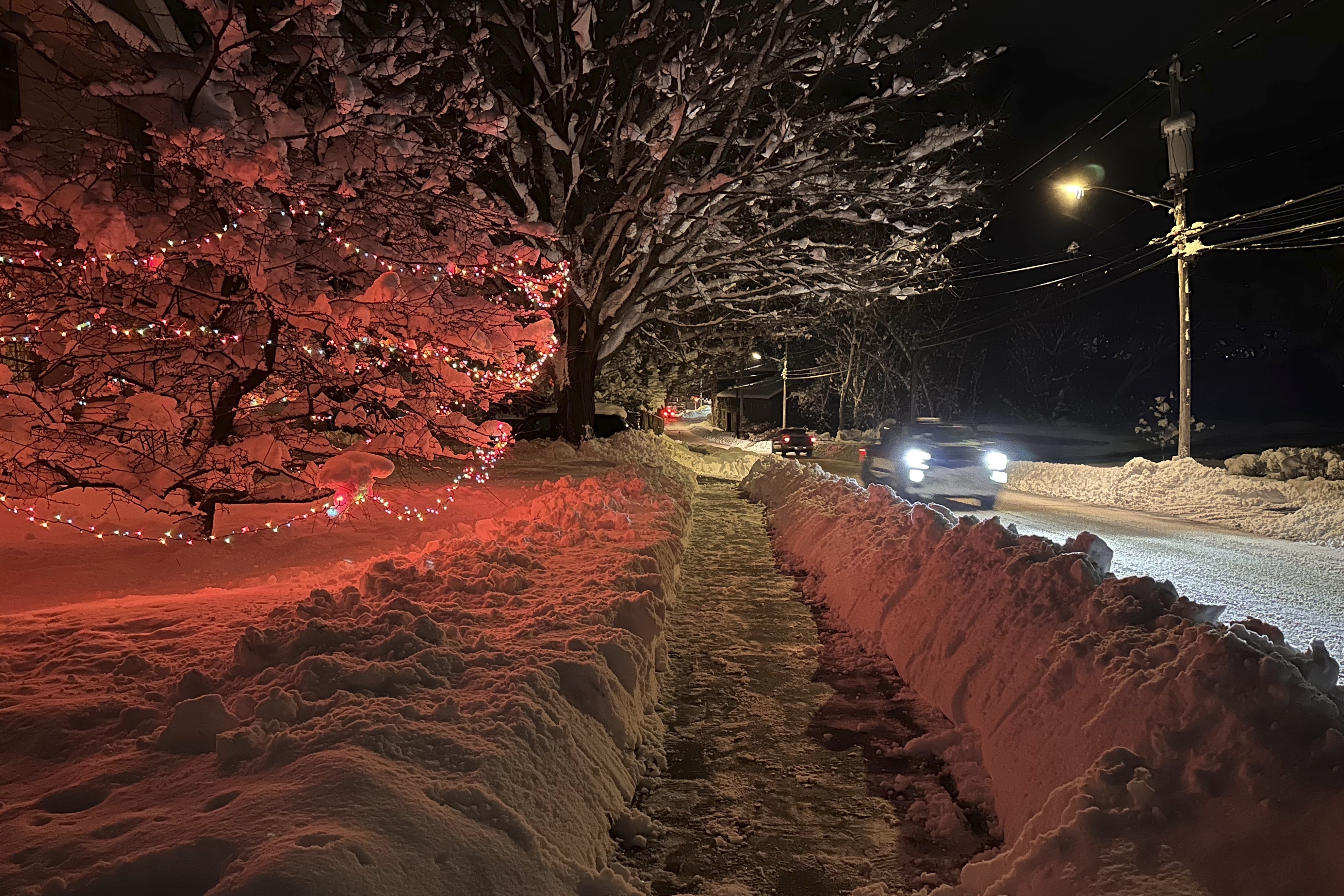 Drivers take advantage of the lull between lake-effect snowfalls in Lowville, N.Y., on Saturday.