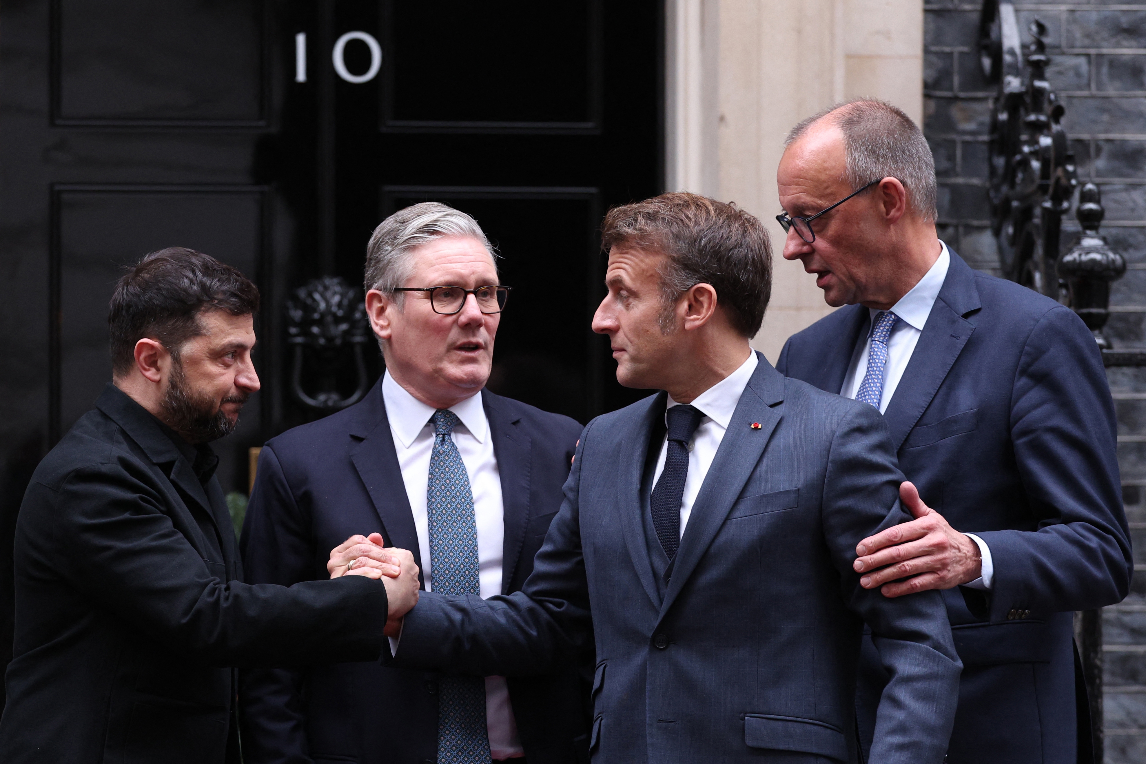 From left: Ukrainian President Volodymyr Zelenskyy, British Prime Minister Keir Starmer, French President Emmanuel Macron and German Chancellor Friedrich Merz chat on the 10 Downing Street doorstep after a meeting in London on Monday.
