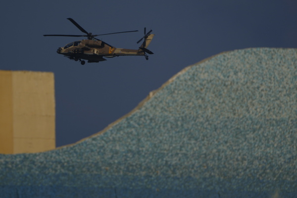 An Israeli Apache helicopter flies over Israel on Sunday.