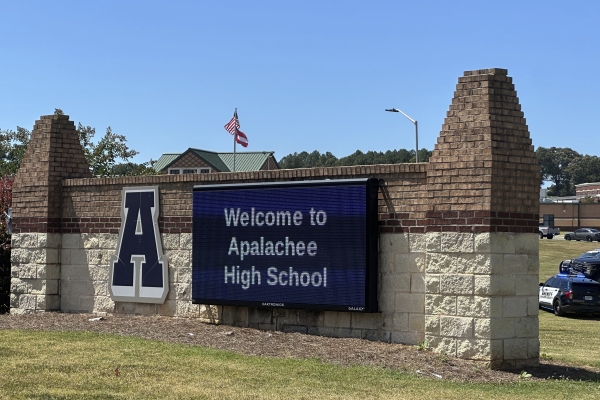 Students were evacuated to the football stadium after the school campus was placed on lockdown at Apalachee High School in Winder, Ga., on Wednesday.
