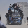 Palestinians hold onto an aid truck returning to Gaza City from the northern Gaza Strip on Tuesday.