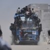 Palestinians hold onto an aid truck returning to Gaza City from the northern Gaza Strip on Tuesday.