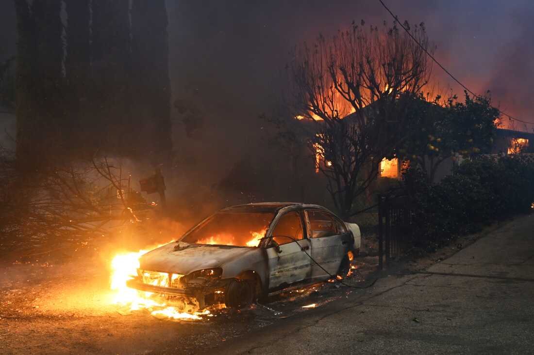 FILE - The Eaton Fire burns vehicles and structures Wednesday, Jan. 8, 2025 in Altadena, Calif.