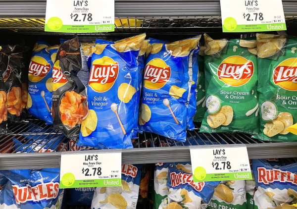 Bags of Lay's chips sit for sale on a store's shelves.