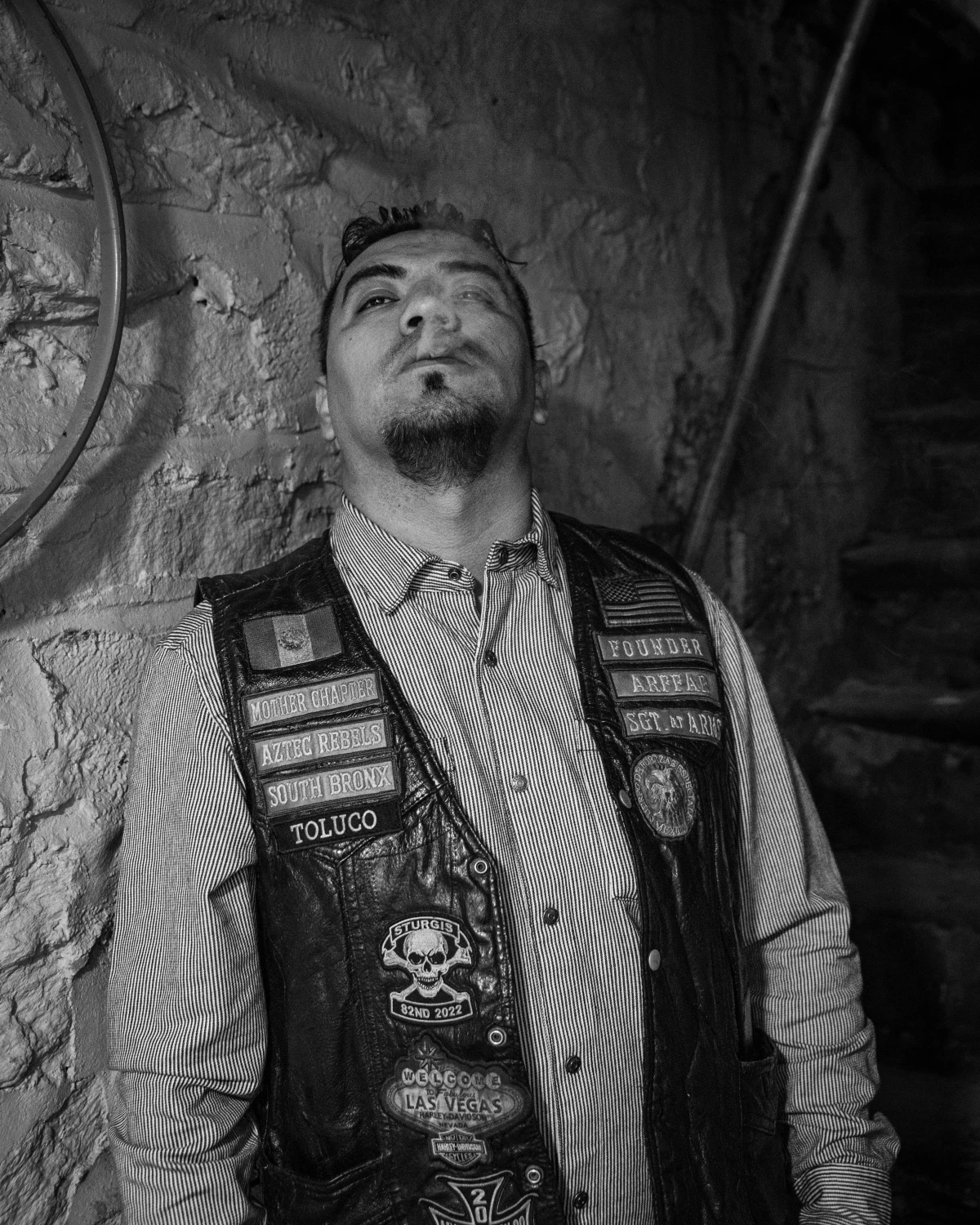 Sergio Garcia, known as Toluco, the Aztec Rebels' Sergeant at Arms, smokes his cigar during a Thanksgiving party.