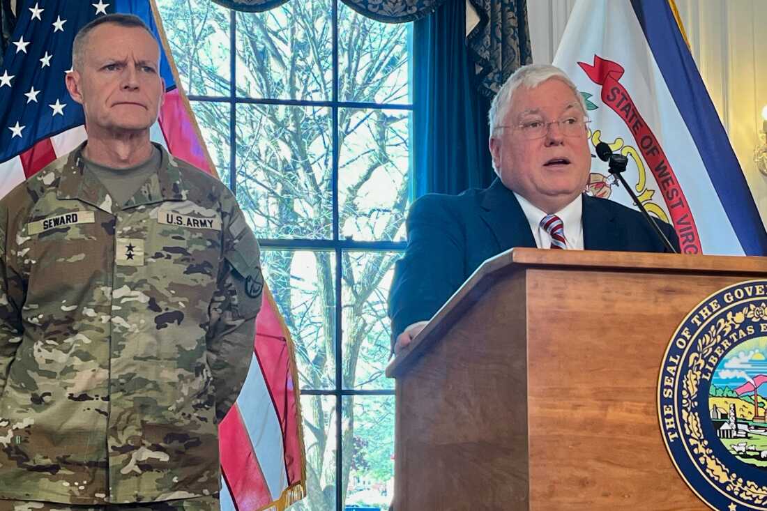 West Virginia Gov. Patrick Morrisey (R) speaks while West Virginia National Guard Maj. Gen. James Seward (L) looks on during a news conference on Dec. 1 at the West Virginia Capitol in Charleston, W.Va.