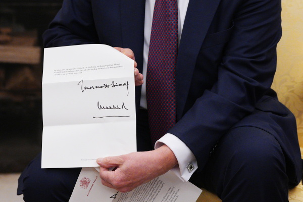 President Trump shows an invitation from King Charles for a second state visit on February 27, 2025.