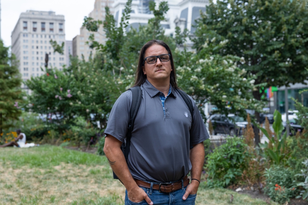 Andrew DiDonato, a construction plan review specialist with Philadelphia's Department of Licenses and Inspections, stands near City Hall on July 22, 2024. After four years of working a hybrid schedule, he's been called back into the office five days a week.