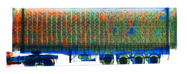 GHANA, Accra, Tema, 2023. X-ray image captured from the screen of Ghanaian customs in the port of Tema. The image shows sound systems piled up. The various colours indicate the various elements which compose the load. At the Port of Tema in Accra, Ghana, the authorities have deployed the latest technology and systems to facilitate X-ray screening for both import and export traffic transiting through the port. The drive-through X-ray portal is capable of scanning 100 to 120 vehicles an hour for explosives, drugs and weapons, and provides manifest verification to reduce the need for manual inspections. The Port of Tema scans 100 percent of containers that pass through it.