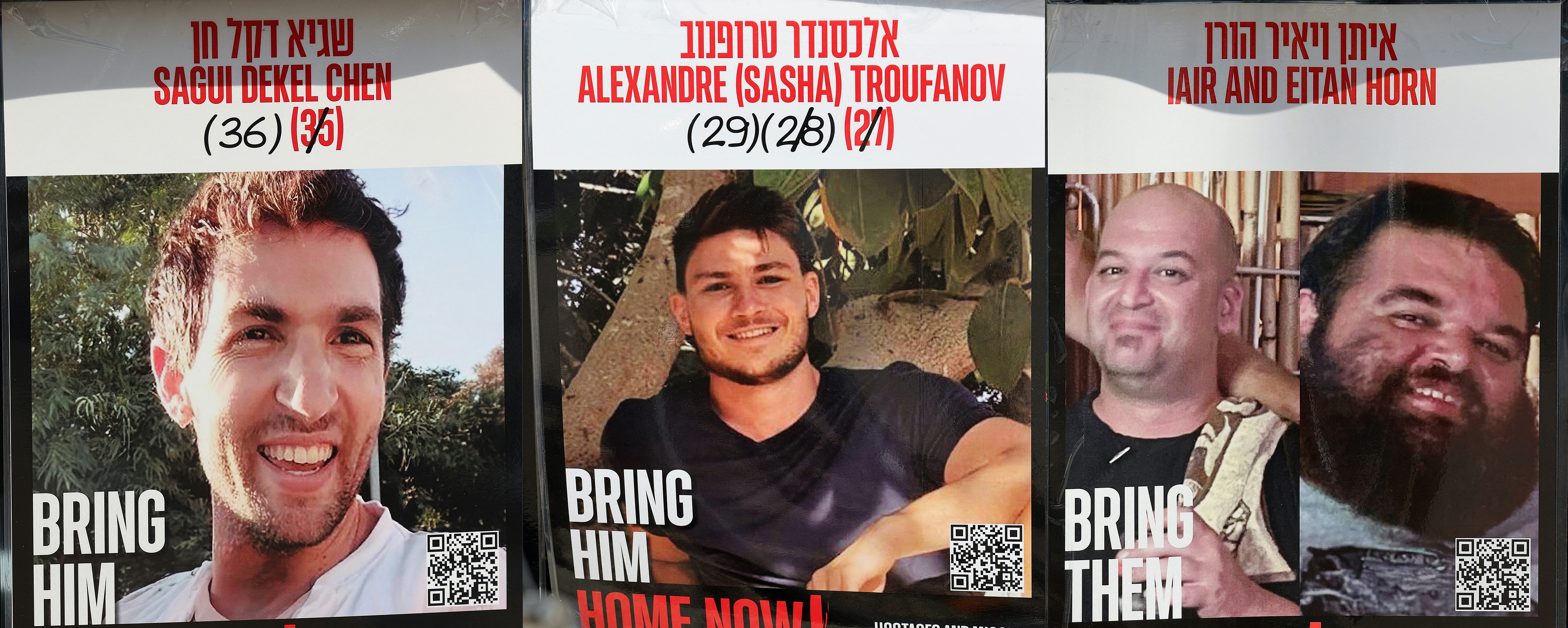 This combination of pictures created on Friday shows posters of three Israeli hostages held in the Gaza Strip since the Oct. 7, 2023: Israeli American Sagui Dekel-Chen, Israeli Russian Alexander "Sasha" Trupanov and Israeli Argentinian Yair Horn. The office of Israeli Prime Minister Benjamin Netanyahu said it had received the names of three hostages to be released by Palestinian militants from Gaza Friday.