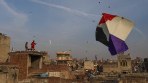 People gather on rooftops in Lahore's Old City to fly kites during Basant.