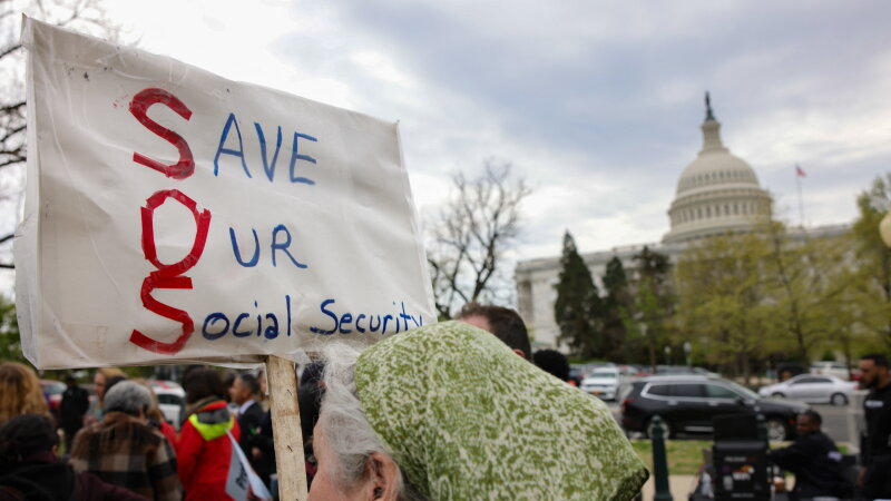 Image 38: A person holds a sign reading "Save Our Social Security" during a rally in support of fair taxation near the U.S. Capitol on April 10, 2025.