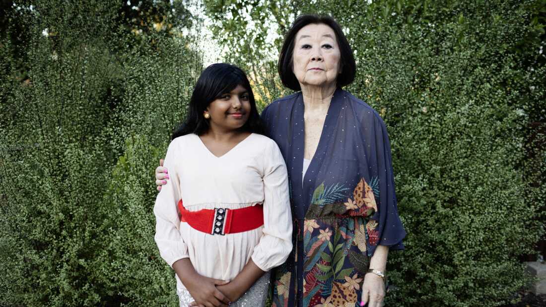 NPR Student Podcast Challenge middle school winner, Ameya Desai poses with Linda Horikawa, an 84-year-old grandmother who Desai did a podcast about her experience being forced out of California and sent to an internment camp in Wyoming as a young girl.