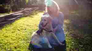 Lilla Lanivich, 14, and her service dog, Lopez, outside their family’s home in Rochester Hills, Mich. This year’s middle school winner of the NPR Student Podcast Challenge tells how her golden retriever, Lopez, helped restore her independence.