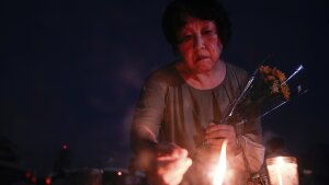 A visitor lights incense sticks at the Peace Memorial Park ahead of the memorial service to mark the 80th anniversary of the WWII U.S. atomic bombing in Hiroshima, Wednesday, Aug. 6, 2025, in Japan.