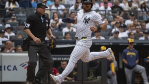New York Yankees' Jasson Domínguez (24) scores during the third inning of a baseball game against the Milwaukee Brewers, Saturday, March 29, 2025, in New York. (AP Photo/Angelina Katsanis)
