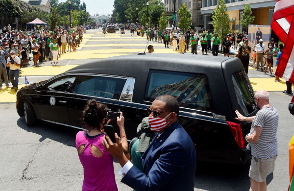 People gather at Black Lives Matter Plaza to watch the funeral procession for congressman and civil rights leader John Lewis on July 27, 2020.