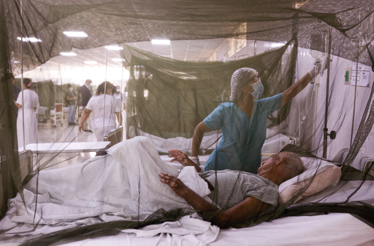 A nurse takes care of a dengue fever patient at the Sergio Bernales National Hospital in the outskirts of Lima on April 17. The number of suspected cases in Peru so far this year is over 100,000.