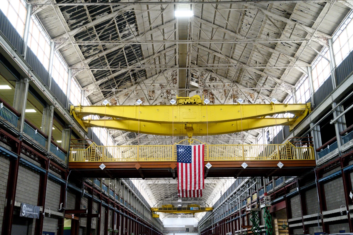 An American flag hangs inside the former Westinghouse plant in Turtle Creek, Pa., which now houses several businesses, including the Eos Energy Enterprises Inc. manufacturing facility.