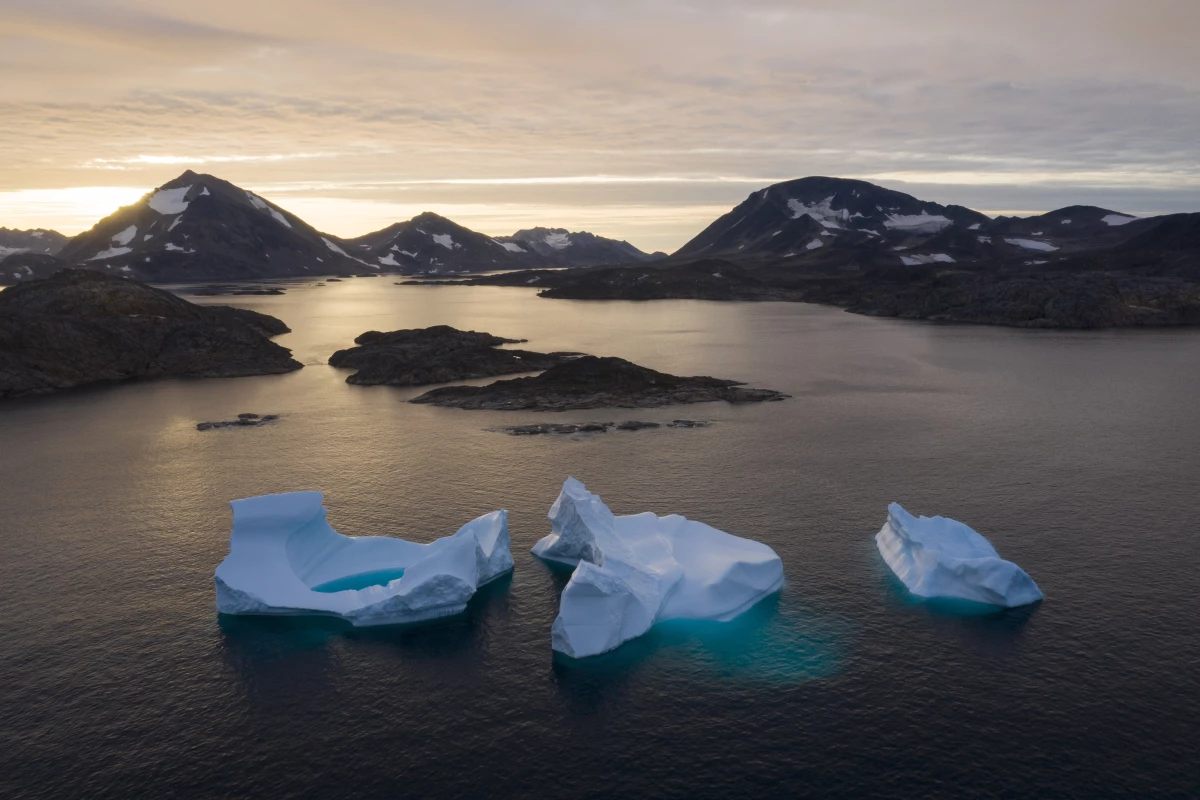 FILE - In this Aug. 16, 2019, photo, large Icebergs float away as the sun rises near Kulusuk, Greenland.