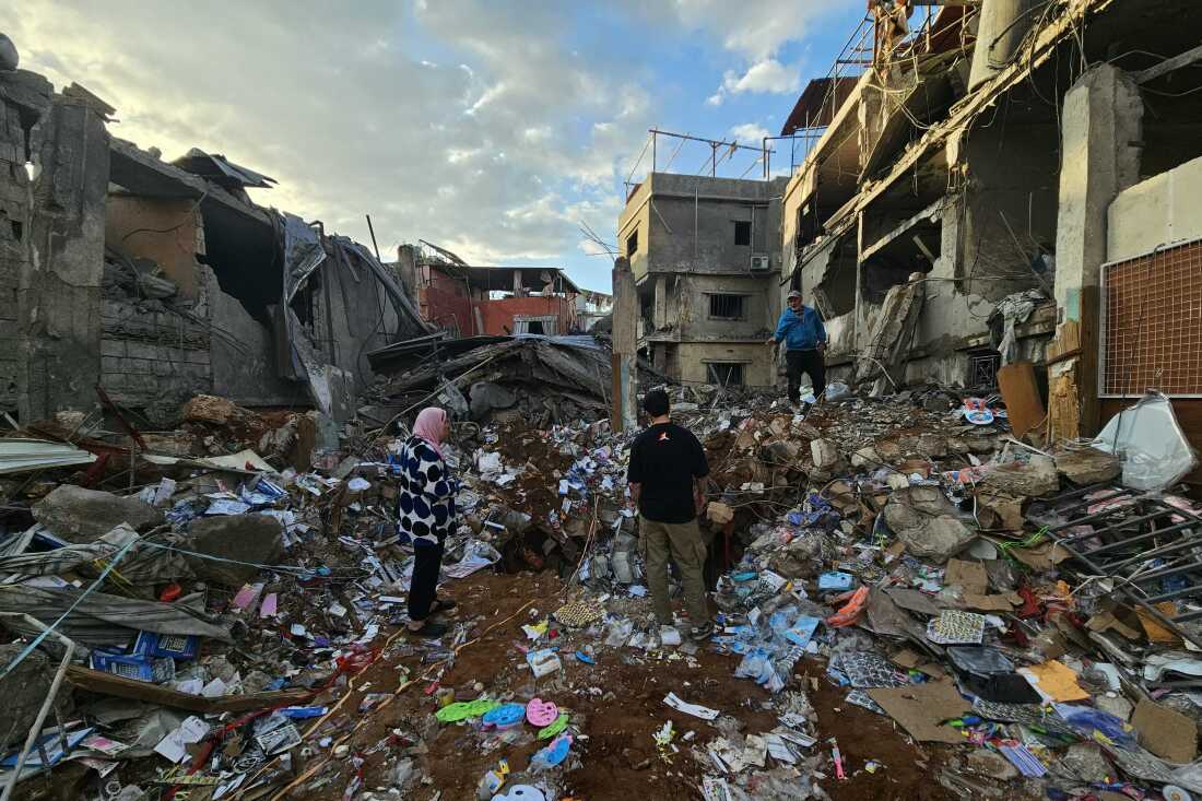People inspect the aftermath of Wednesday's Israeli airstrikes that targeted southern Beirut's al-Rihab neighborhood, April 9. T