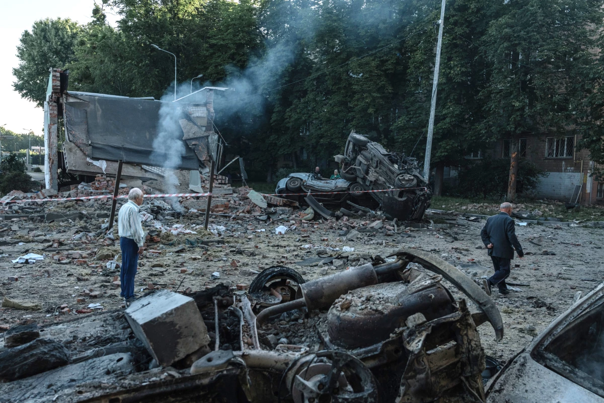 Residents inspect the damage following a Russian air strike in a residential area of Kyiv, Ukraine.