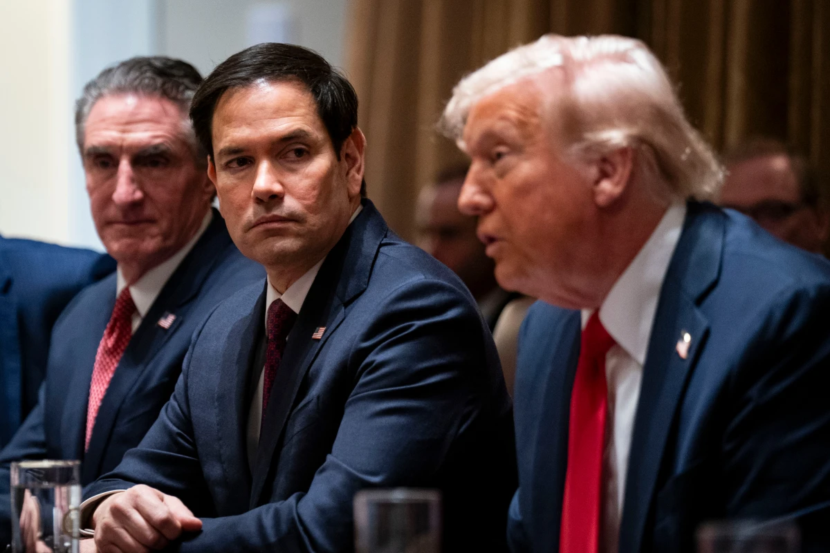 Secretary of State Rubio (center) flanked by Doug Burgum, secretary of the interior, and President Donald Trump during a cabinet meeting on Feb. 26. On Monday, Rubio posted on X that 83% of USAID contracts had been canceled following a review.
