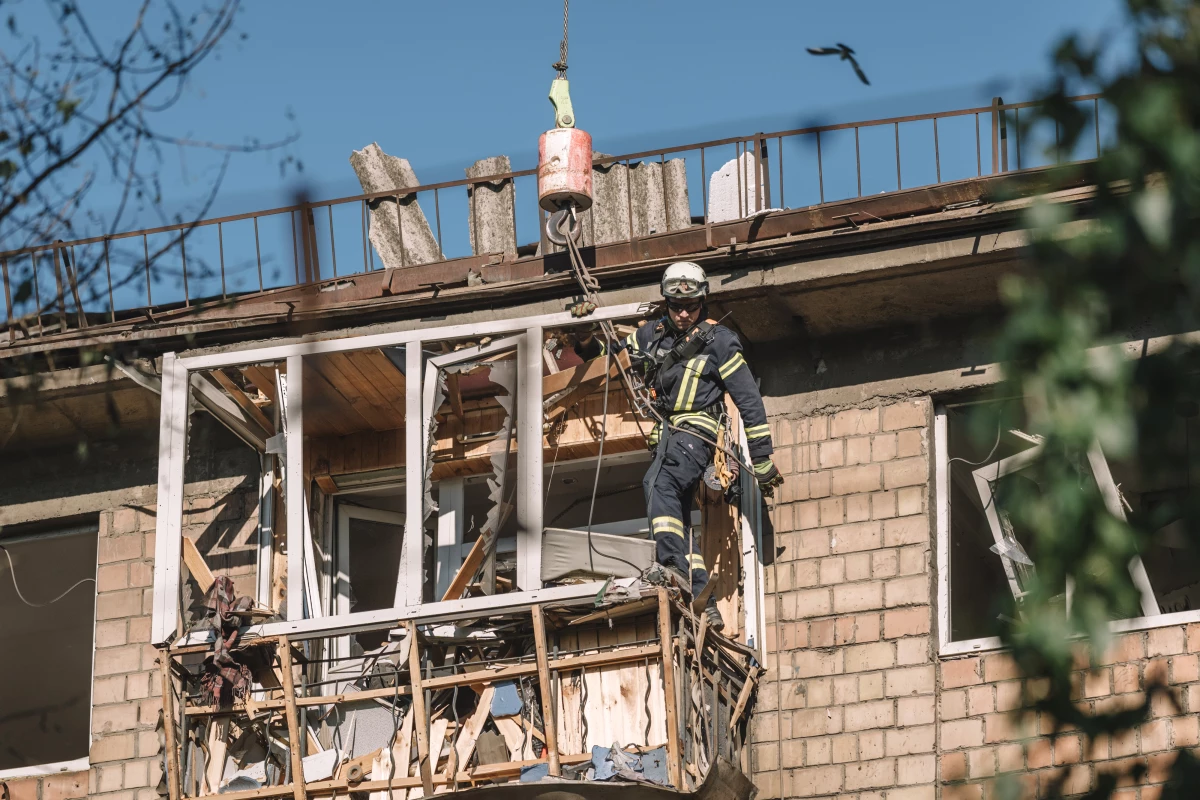 A rescue worker works at the site of a Russian air strike on a residential building in Kyiv, Ukraine.